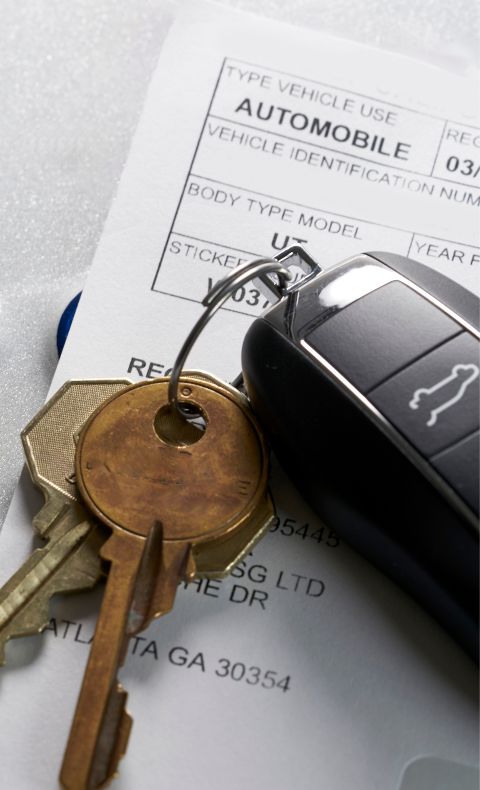 Close-up of car keys and a vehicle registration document, representing South Dakota vehicle registration services.